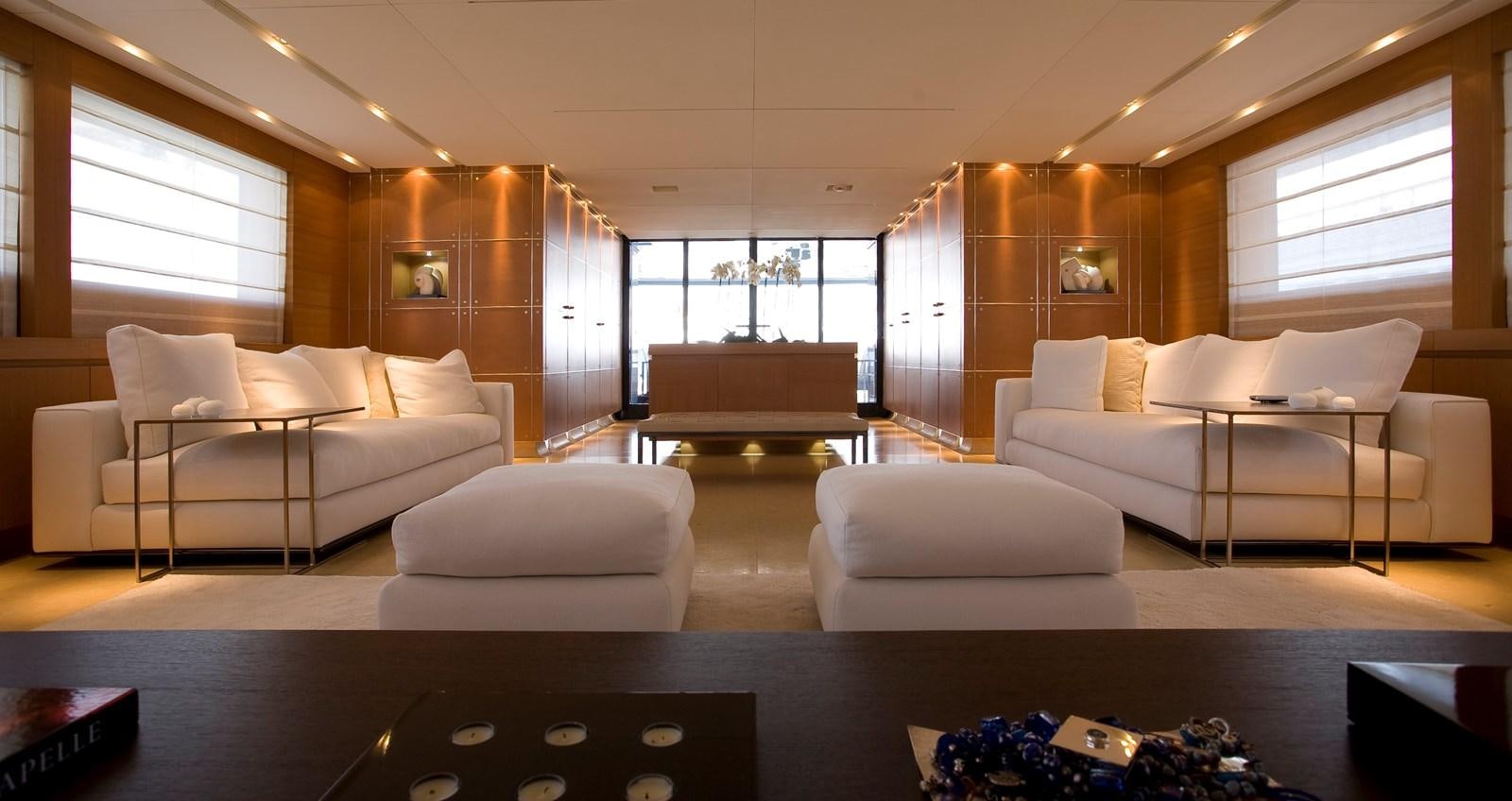 a living room with a couch and a table aboard QUEEN BLUE Yacht for Sale