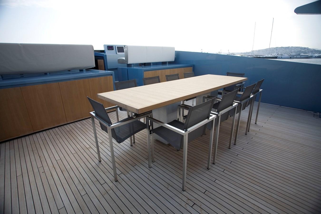 a table and chairs on a deck aboard QUEEN BLUE Yacht for Sale