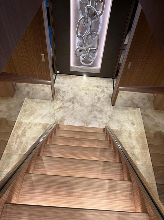 a wooden staircase with a metal railing aboard RANDY BETH Yacht for Sale
