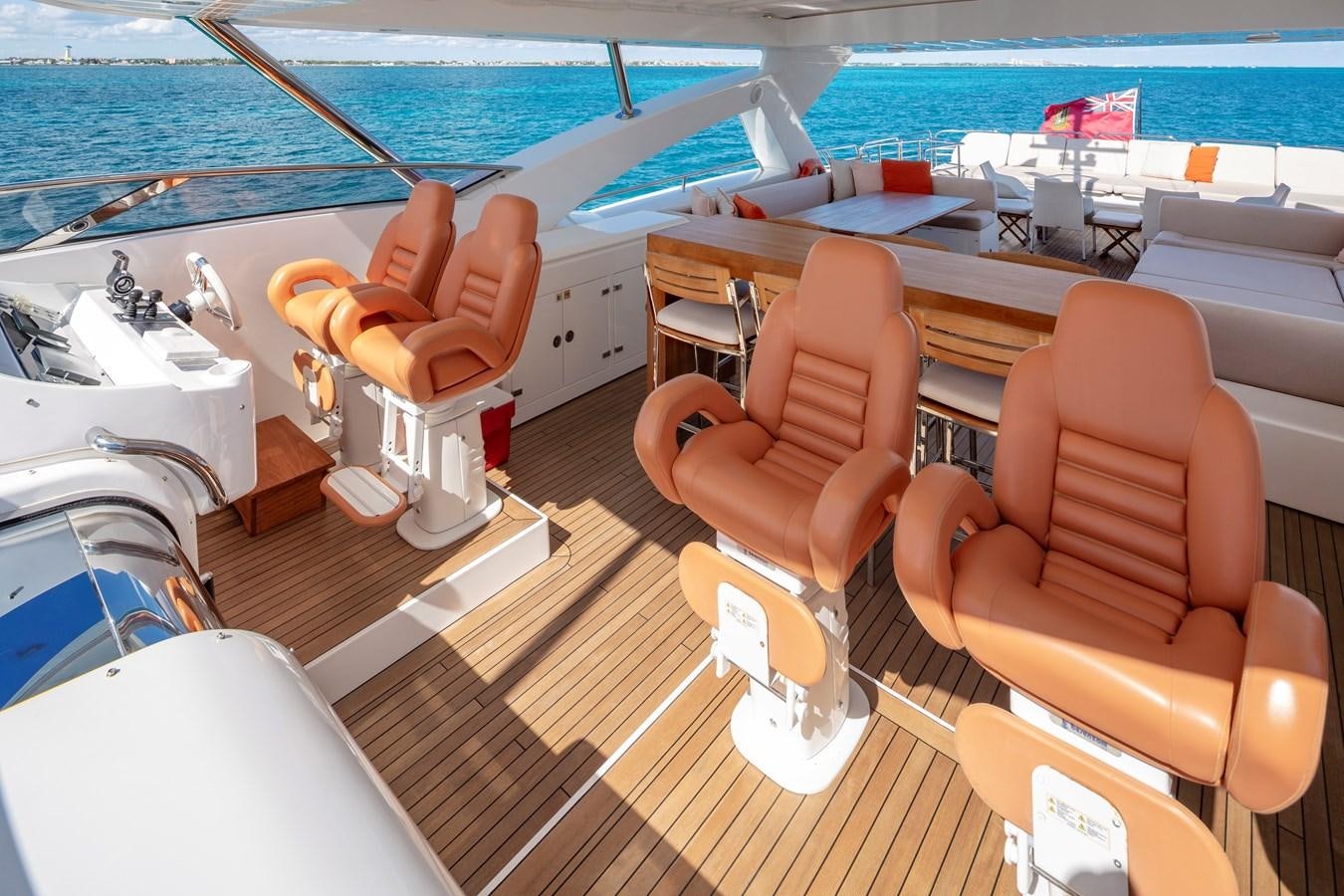 a couple of orange chairs on a deck next to a pool aboard 2010 SUNSEEKER 34M  @ AVENTURA FL Yacht for Sale