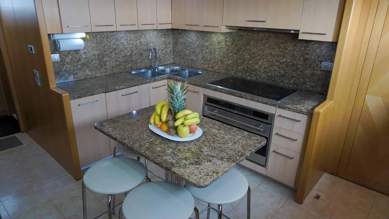 a kitchen with a bowl of fruit aboard PETRUS Yacht for Sale