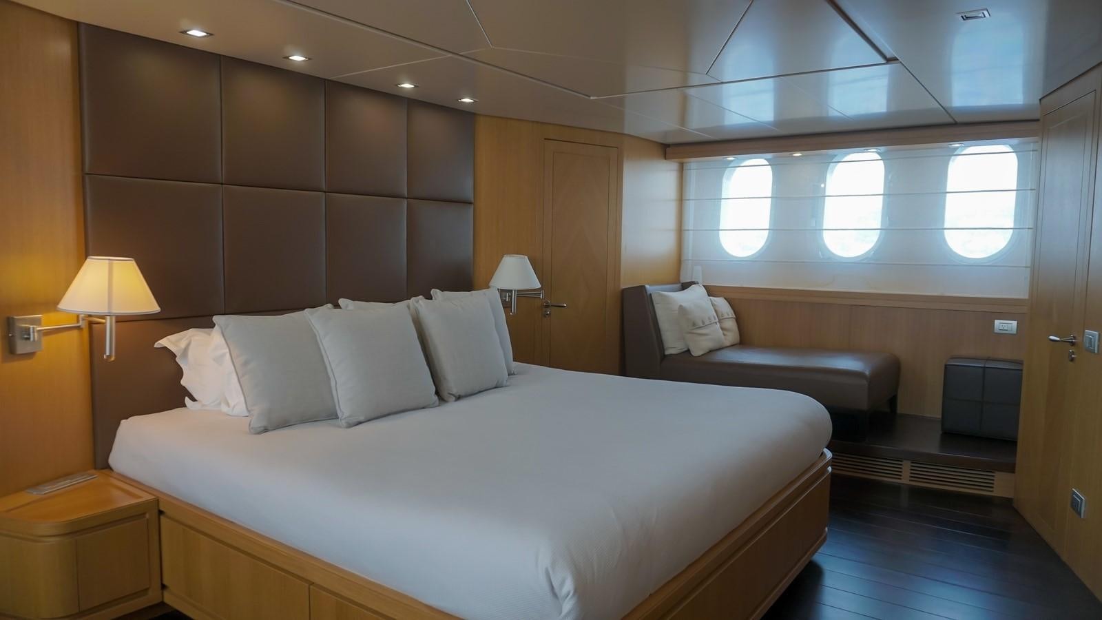 a room with a bed and a couch aboard PETRUS Yacht for Sale