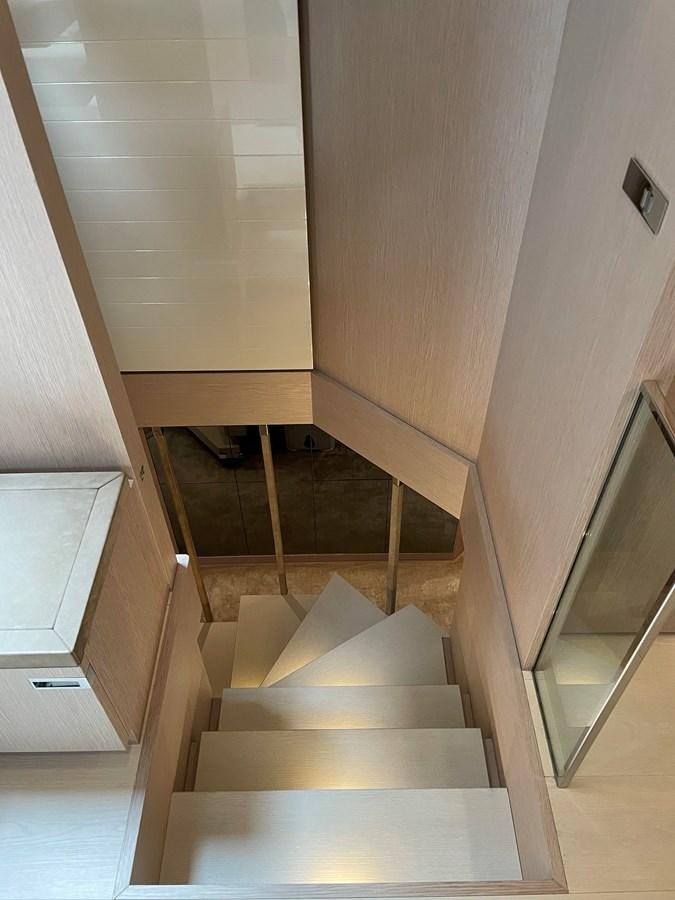 a staircase with a wood railing aboard CUSTOM LINE 108 Yacht for Sale