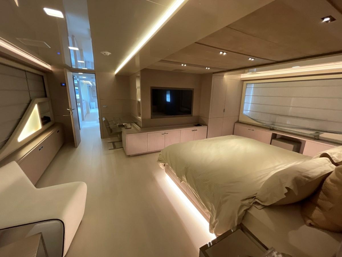a room with a bed and a tv aboard CUSTOM LINE 108 Yacht for Sale