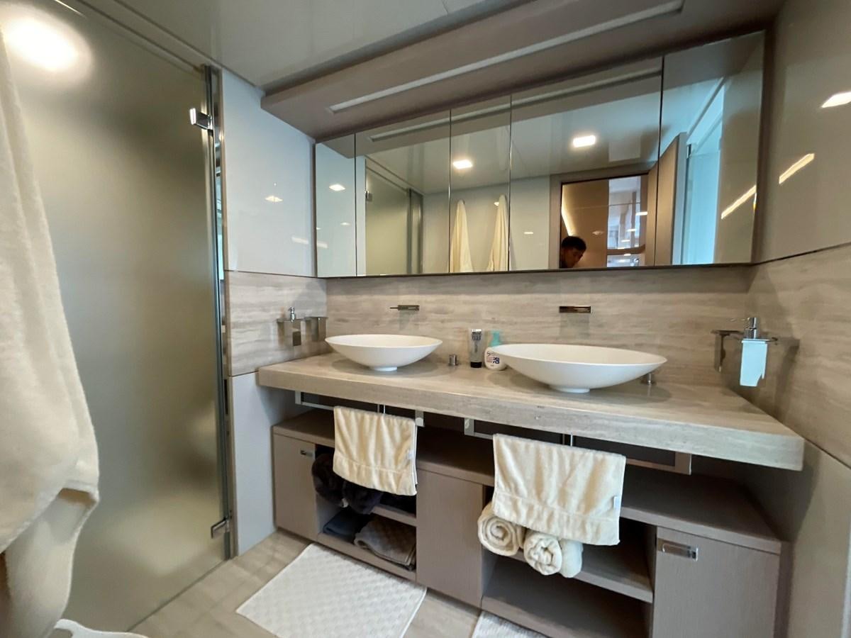 a bathroom with two sinks and a large mirror aboard CUSTOM LINE 108 Yacht for Sale