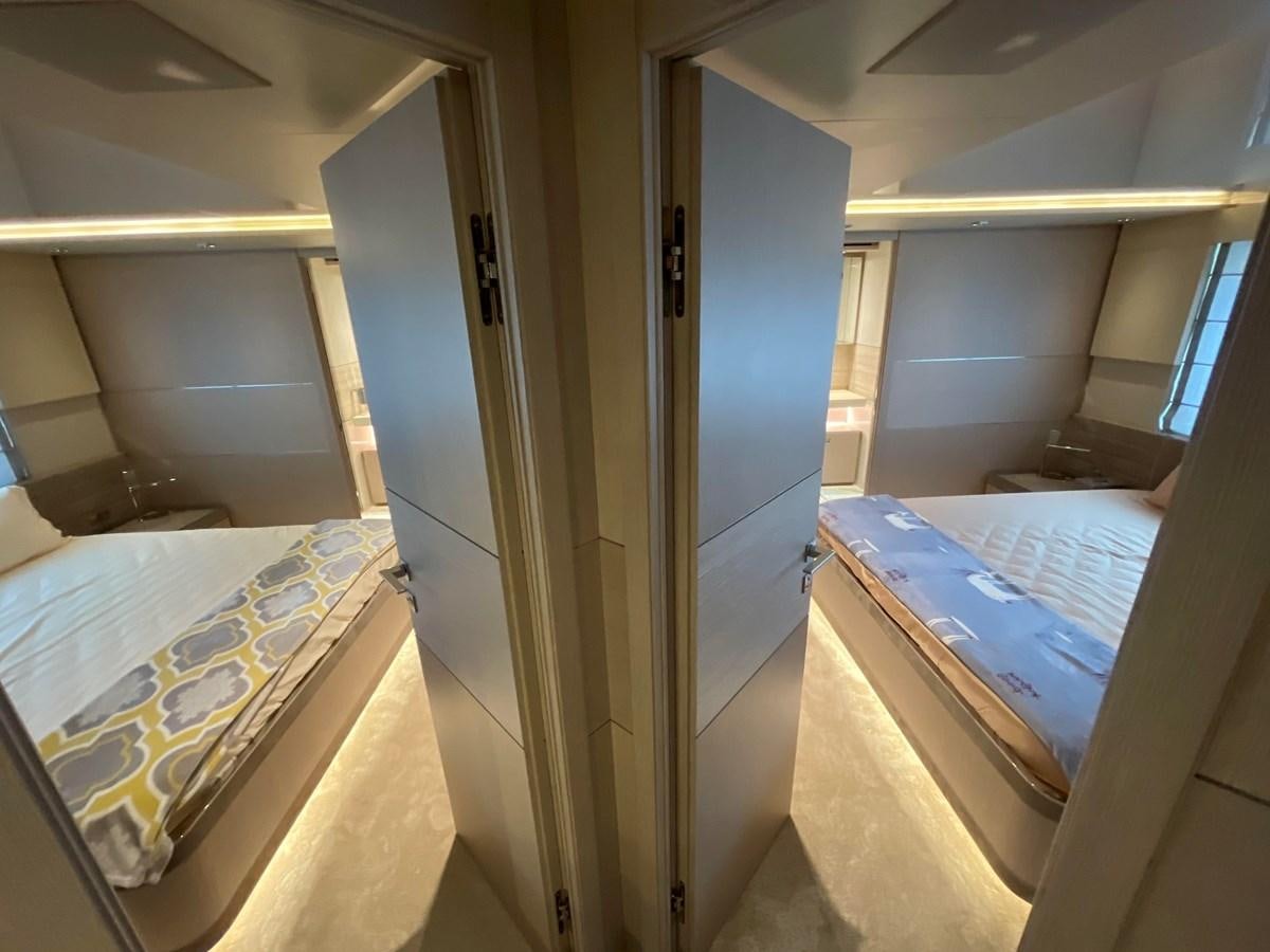 a room with a bed and a closet aboard CUSTOM LINE 108 Yacht for Sale
