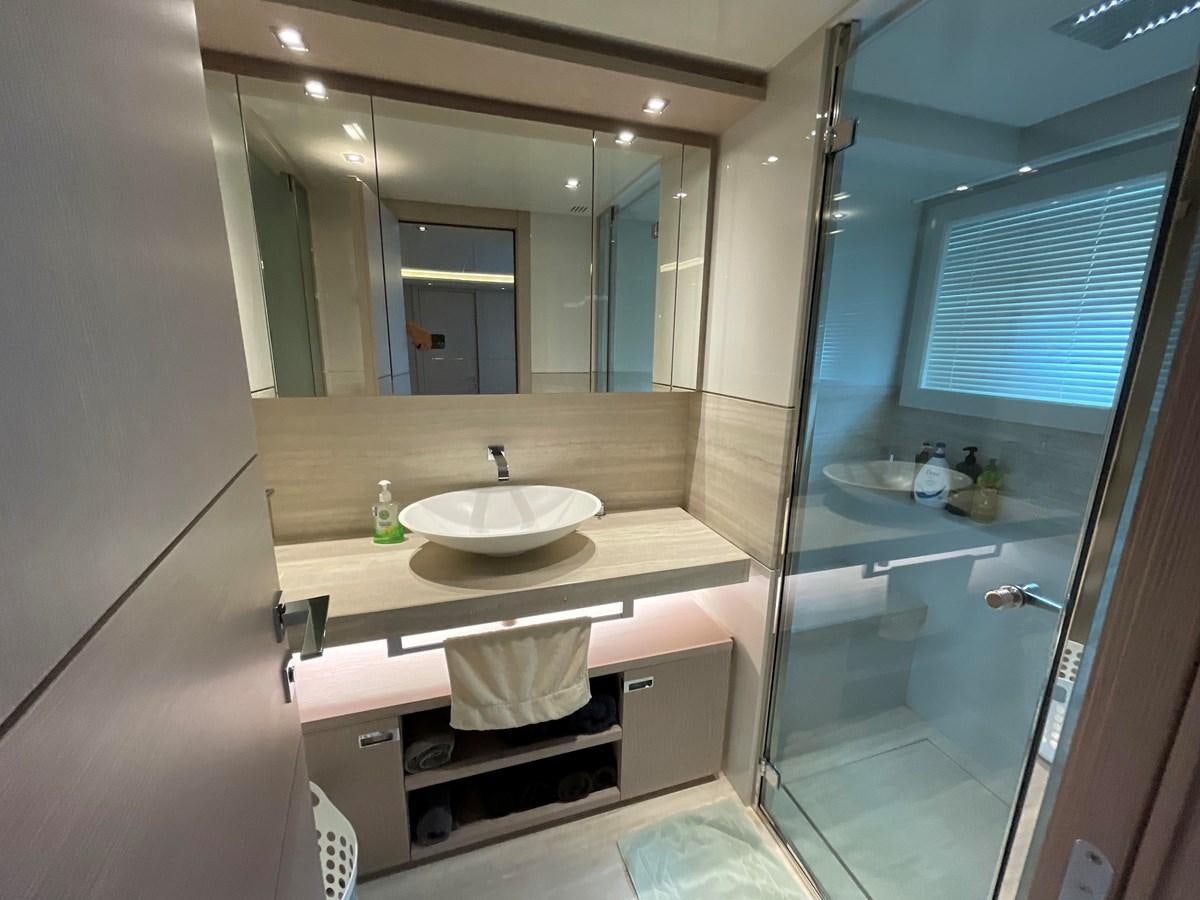 a bathroom with a sink and a mirror aboard CUSTOM LINE 108 Yacht for Sale