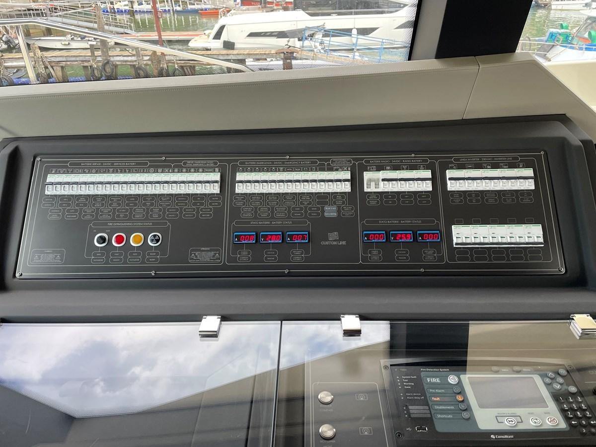 a black computer with buttons and a screen aboard CUSTOM LINE 108 Yacht for Sale