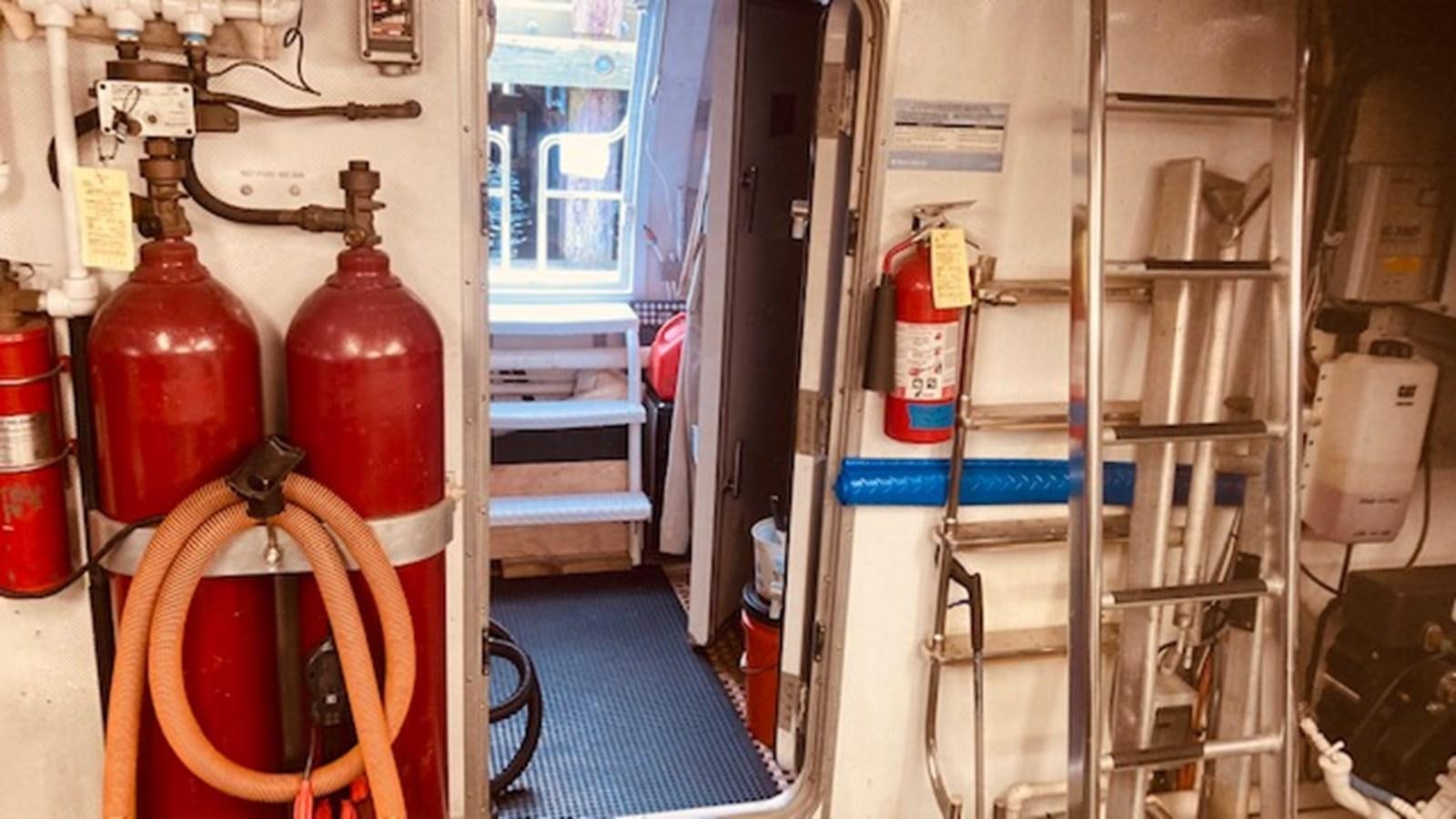 a room with a few bottles and a ladder aboard VICTORY Yacht for Sale