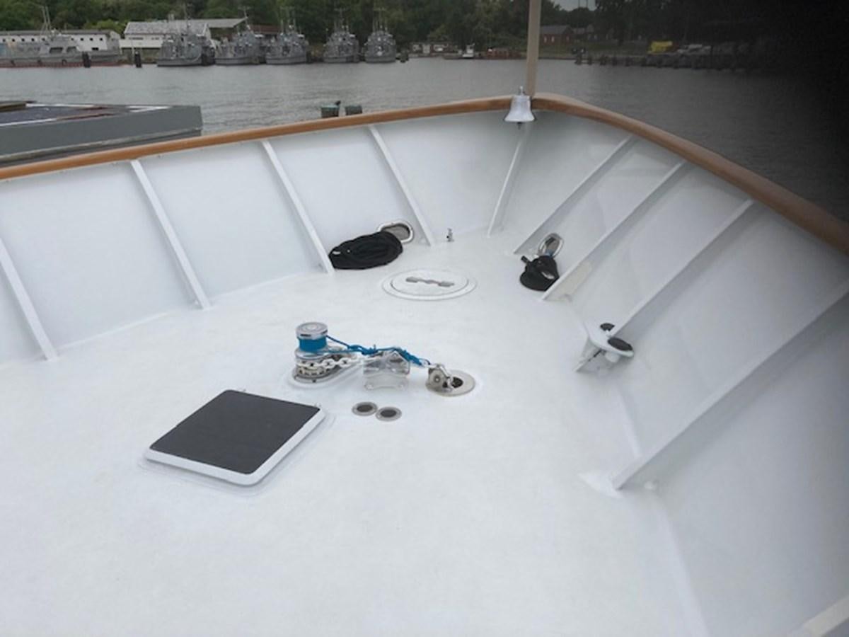 a laptop sits on a table aboard VICTORY Yacht for Sale