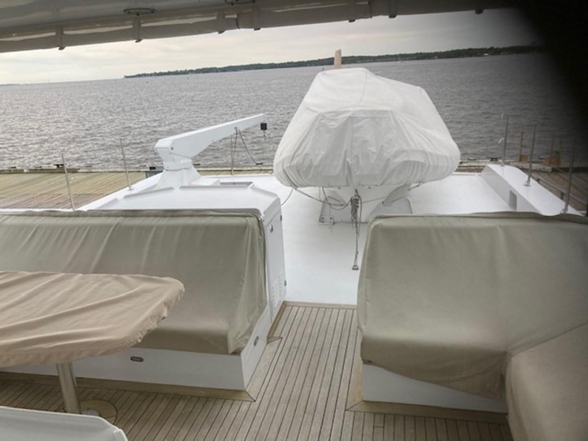a group of white beds on a deck aboard VICTORY Yacht for Sale