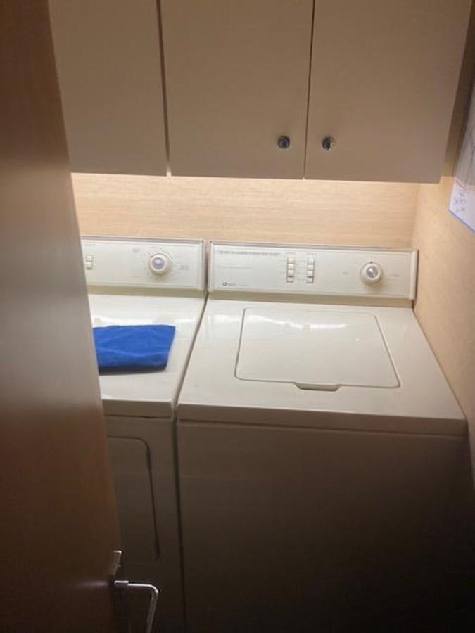 a washing machine in a kitchen aboard VICTORY Yacht for Sale