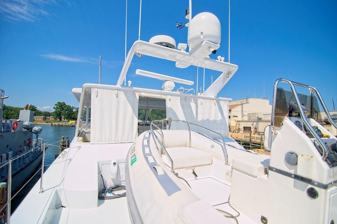 a white boat in a harbor aboard VICTORY Yacht for Sale