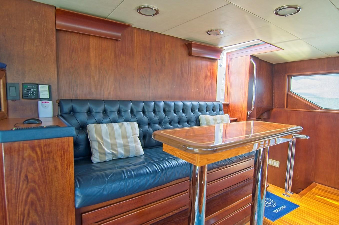 a living room with a couch and a table aboard VICTORY Yacht for Sale