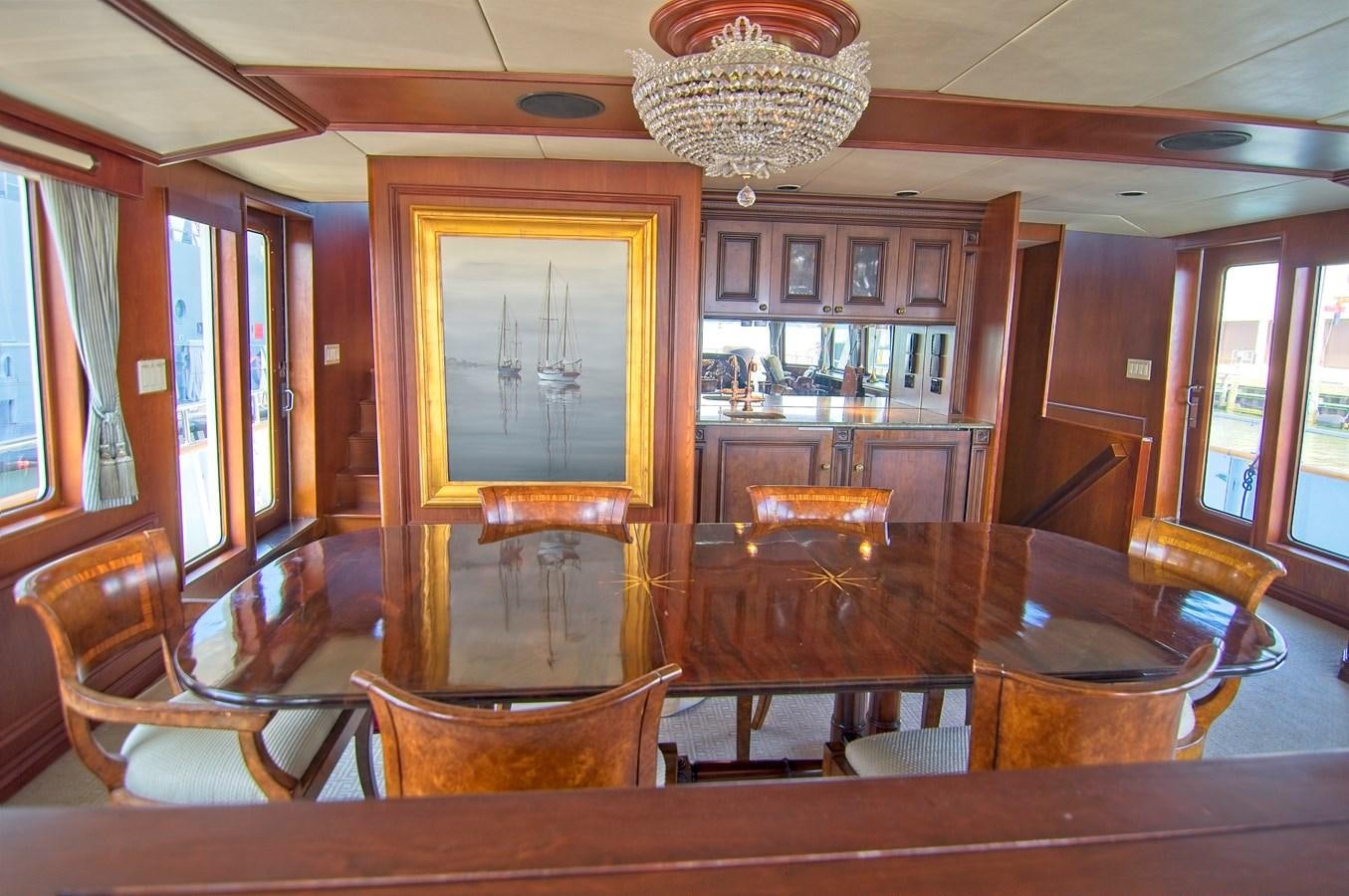 a room with a table and chairs aboard VICTORY Yacht for Sale