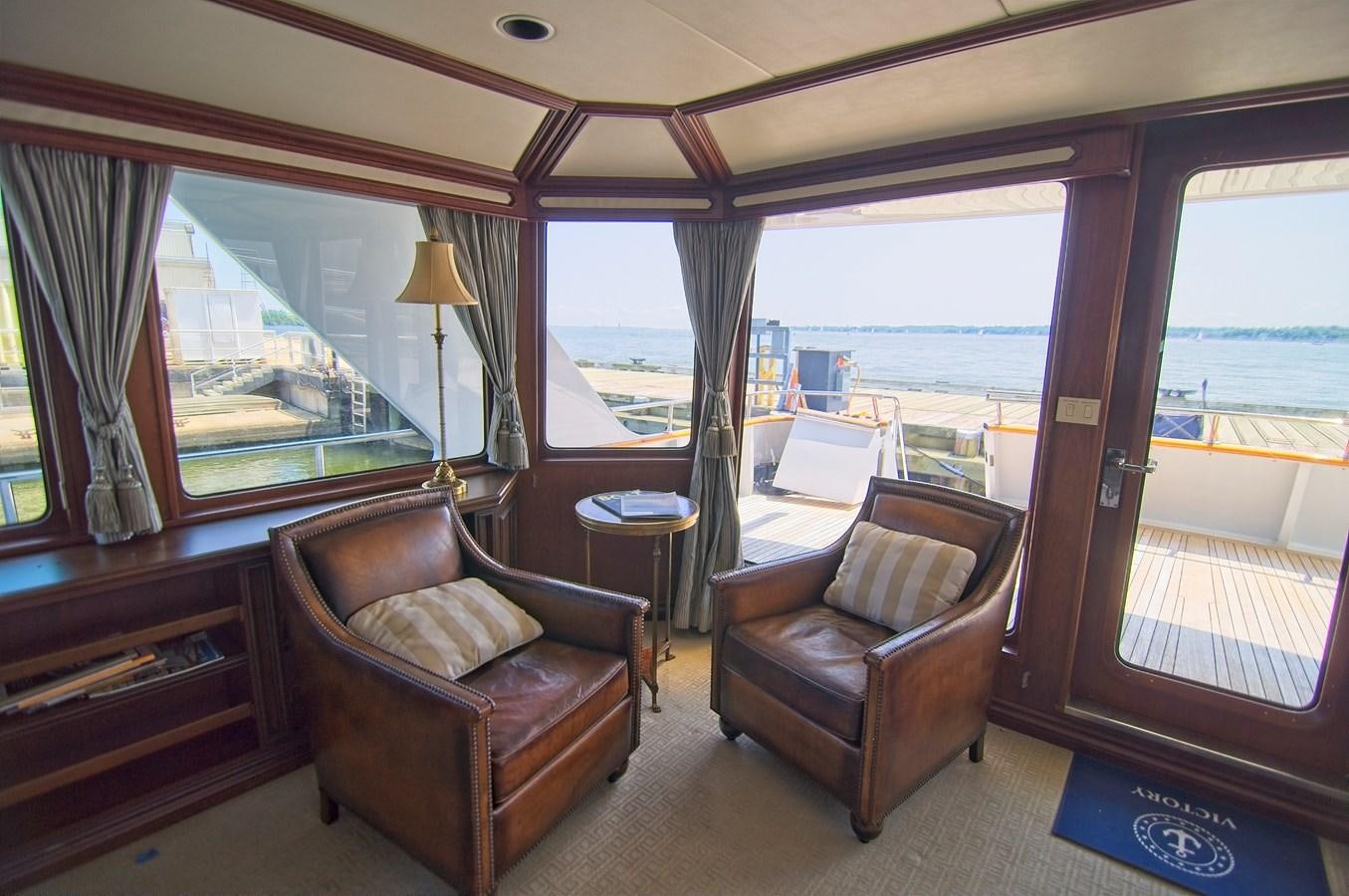 a living room with a view of the city aboard VICTORY Yacht for Sale