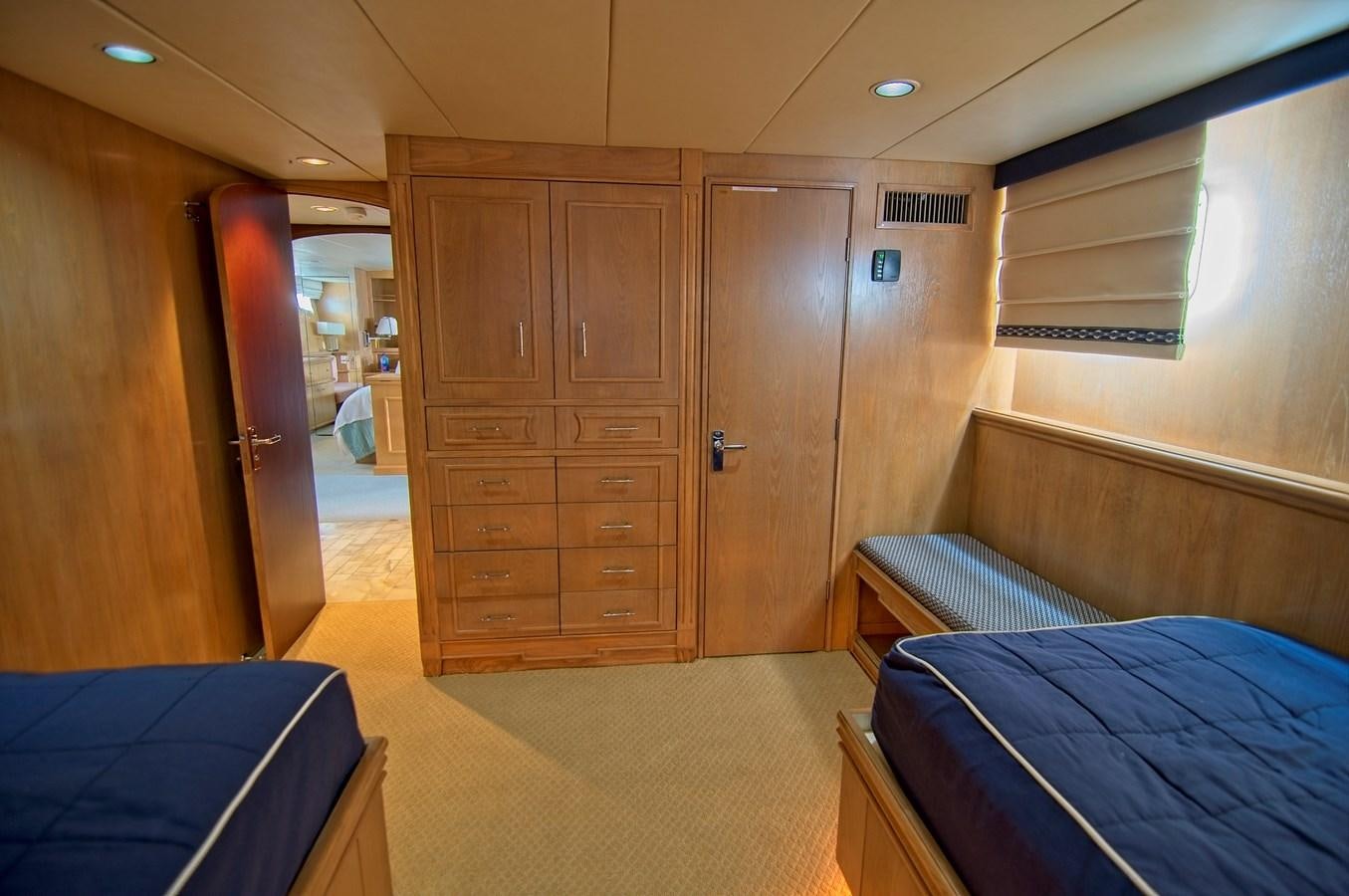 a room with a bed and a closet aboard VICTORY Yacht for Sale