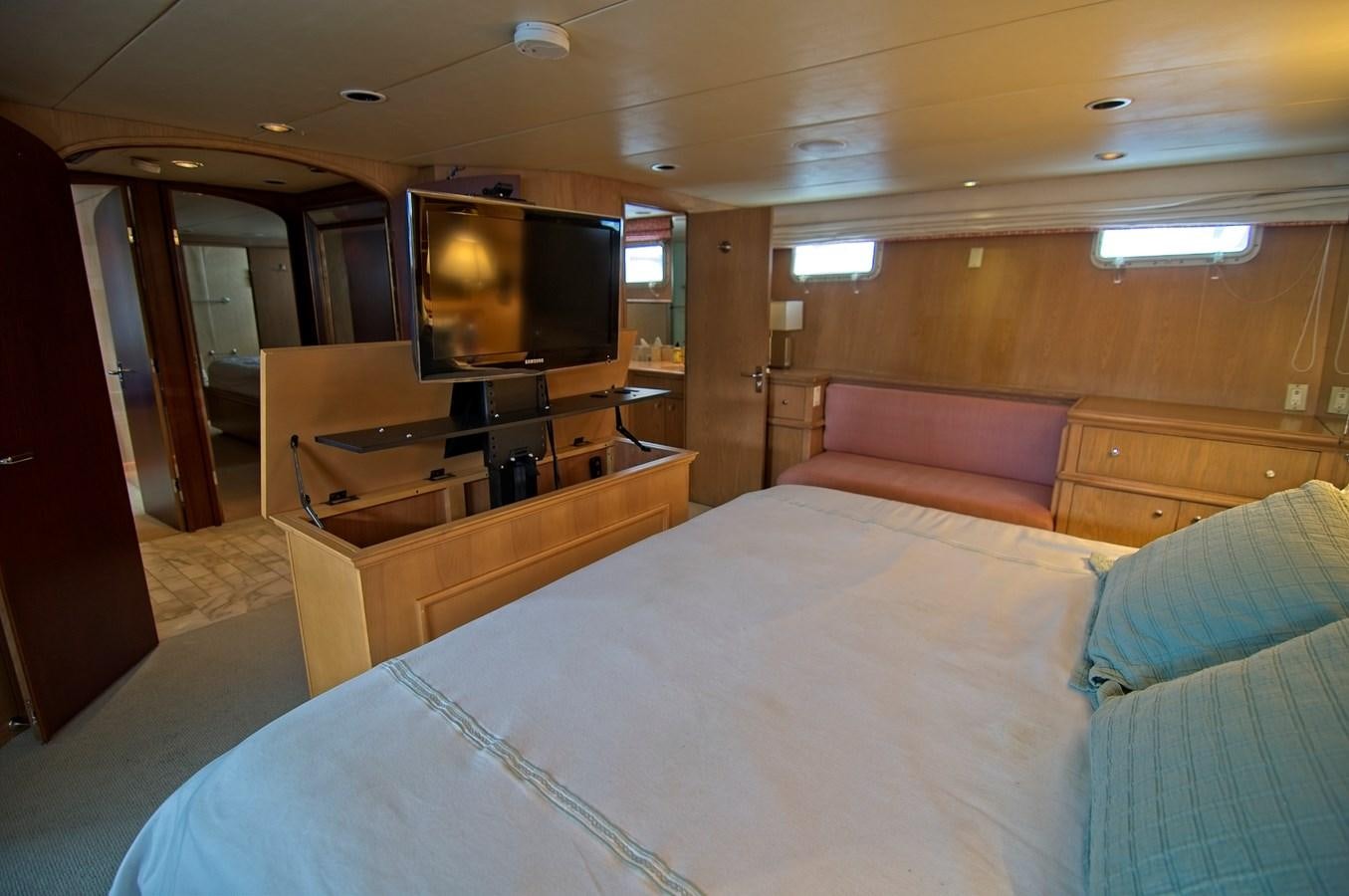 a hotel room with a bed and tv aboard VICTORY Yacht for Sale