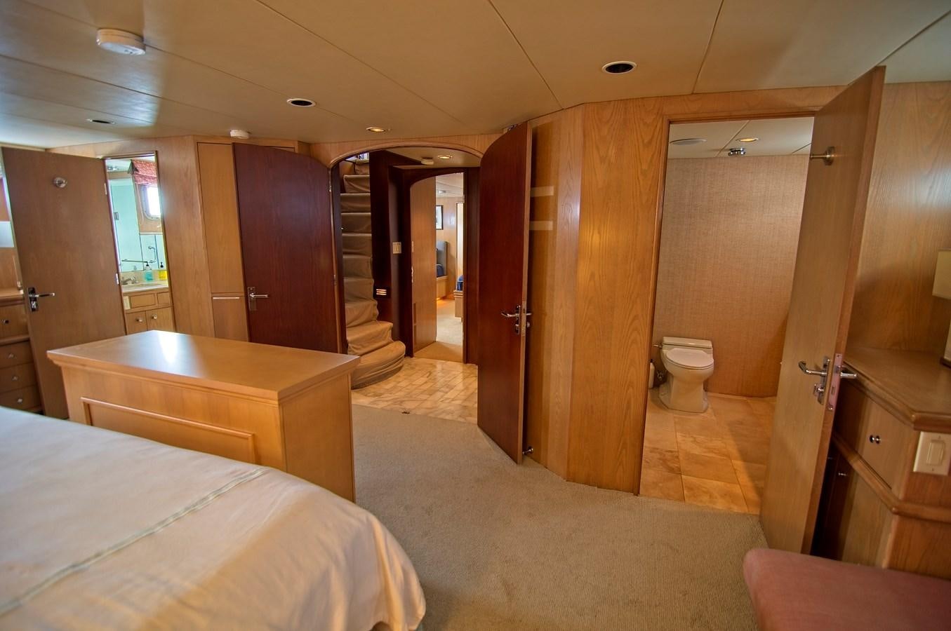 a room with a bed and a closet aboard VICTORY Yacht for Sale
