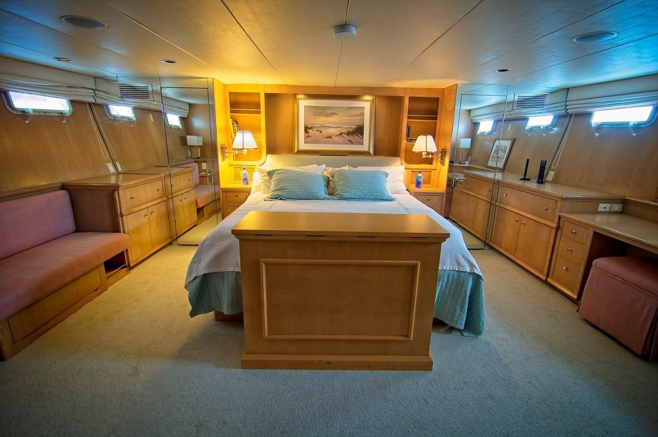 a room with a bed and a couch aboard VICTORY Yacht for Sale