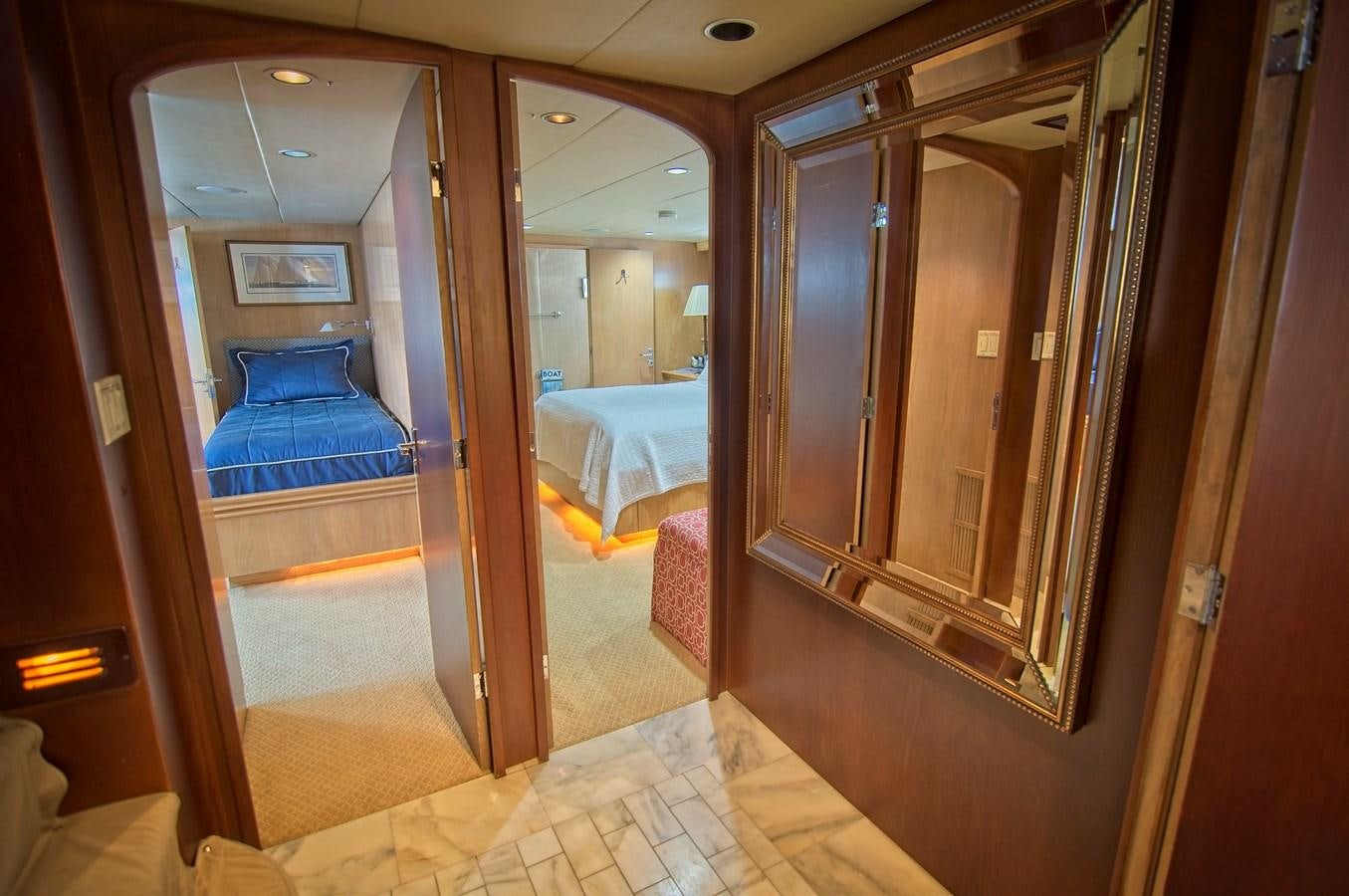 a room with a bed and a mirror aboard VICTORY Yacht for Sale