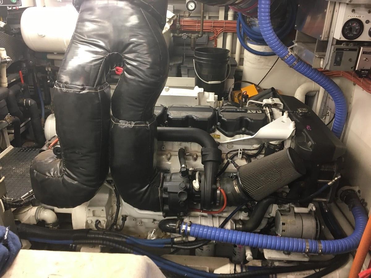 a person working on a car engine aboard VICTORY Yacht for Sale