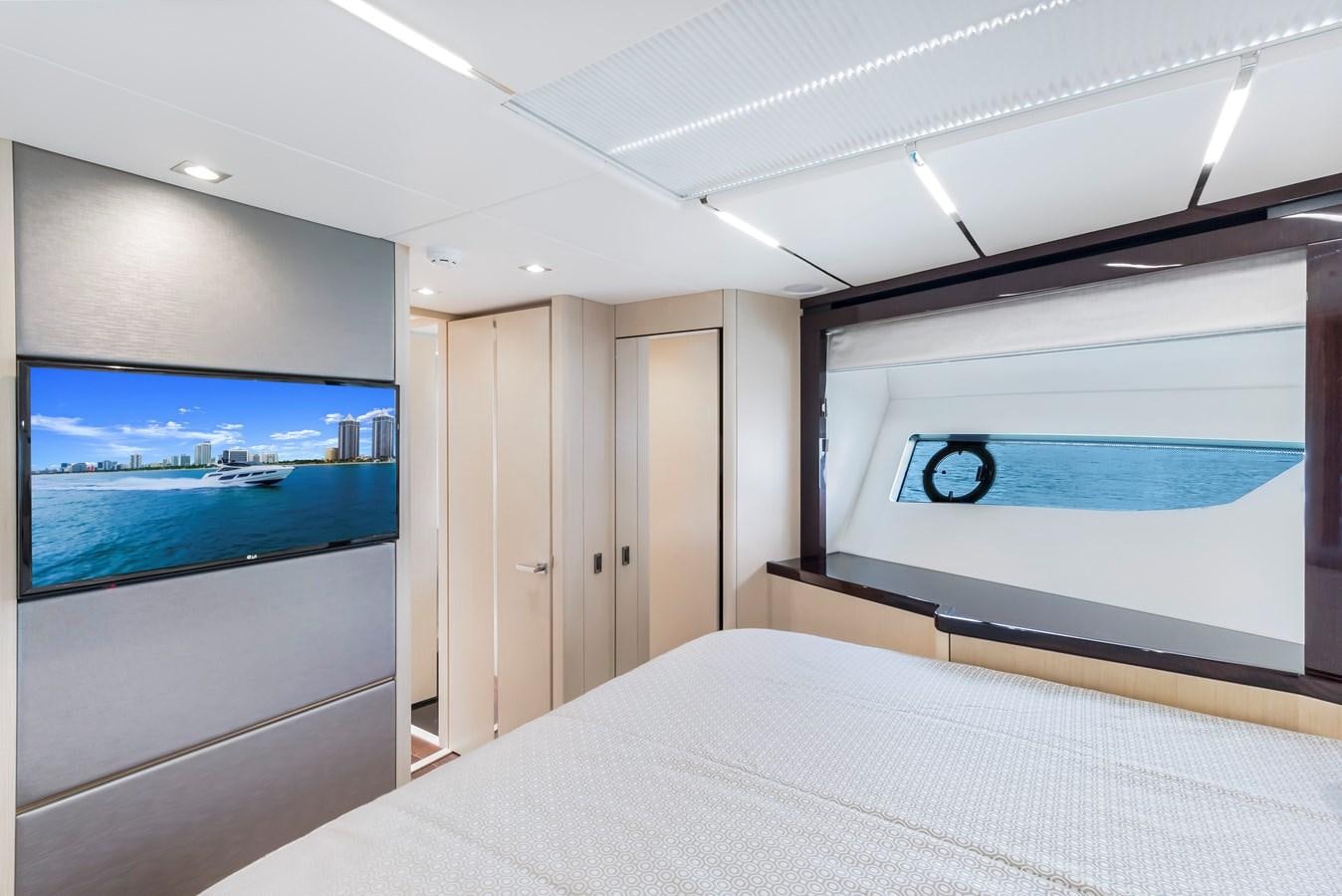 a room with a bed and a tv on the wall aboard SUNSEEKER PREDATOR Yacht for Sale