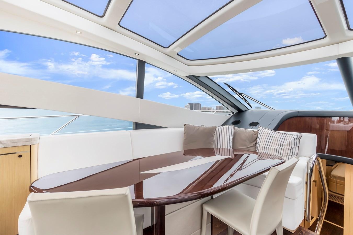 a room with a bed and chairs aboard SUNSEEKER PREDATOR Yacht for Sale