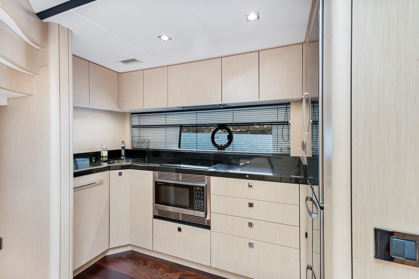 a kitchen with white cabinets aboard SUNSEEKER PREDATOR Yacht for Sale