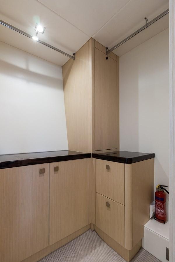 a room with wooden cabinets aboard SUNSEEKER PREDATOR Yacht for Sale