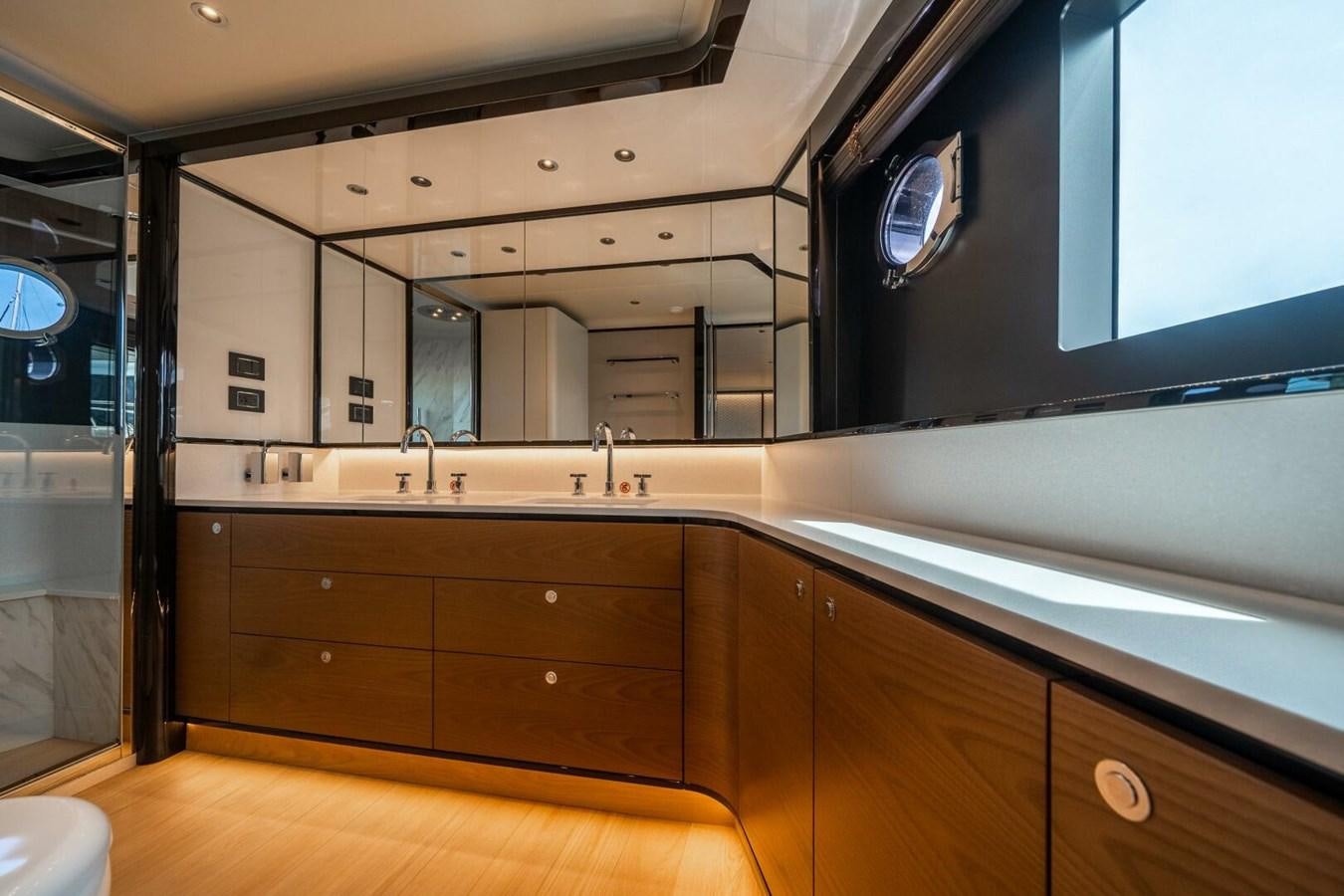 a bathroom with a large mirror aboard NAVETTA 68 Yacht for Sale