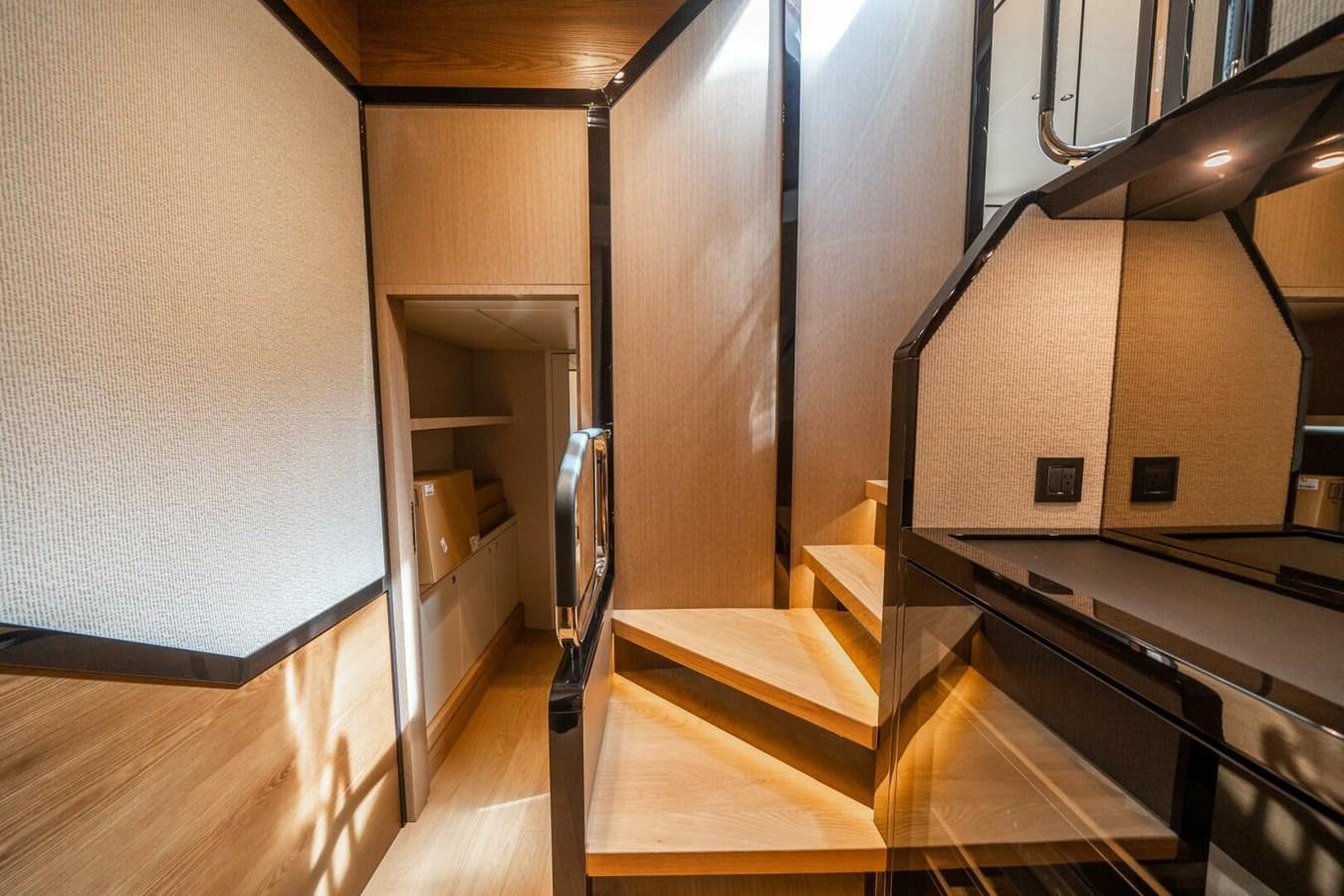 a kitchen with wooden cabinets aboard NAVETTA 68 Yacht for Sale