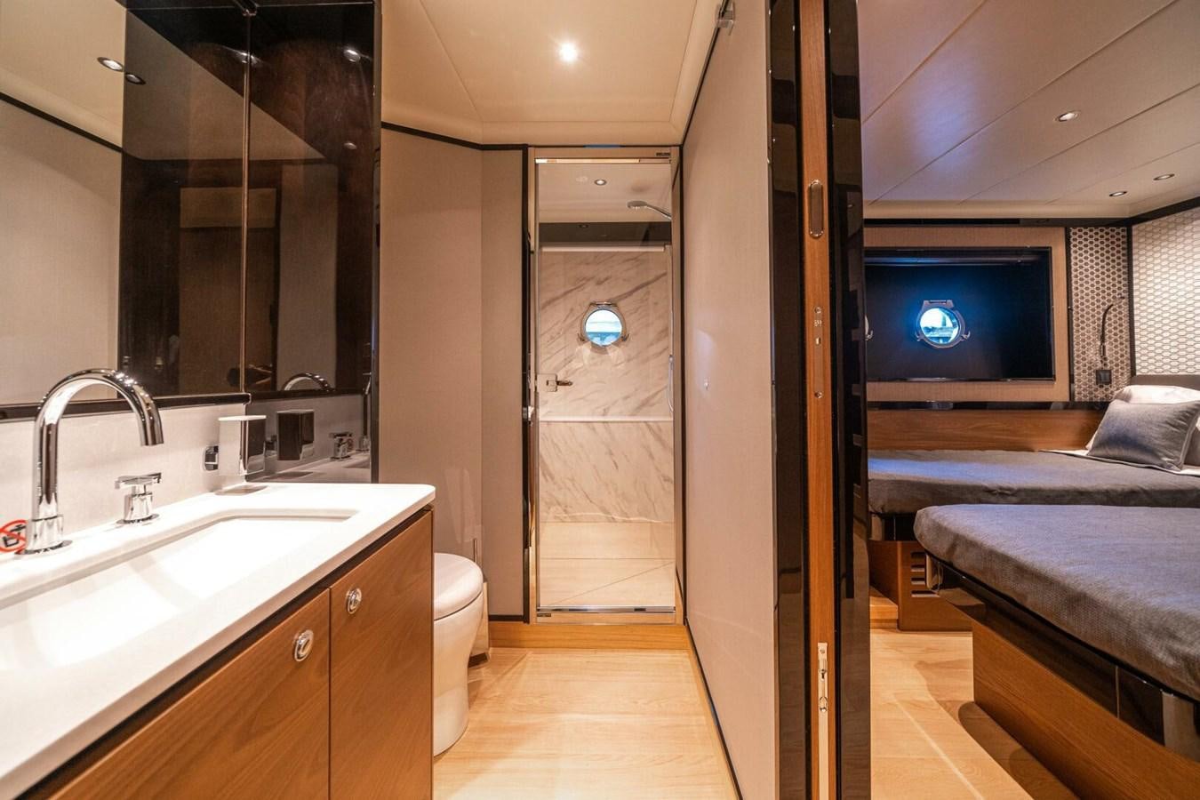 a bedroom with a bed and a tv aboard NAVETTA 68 Yacht for Sale