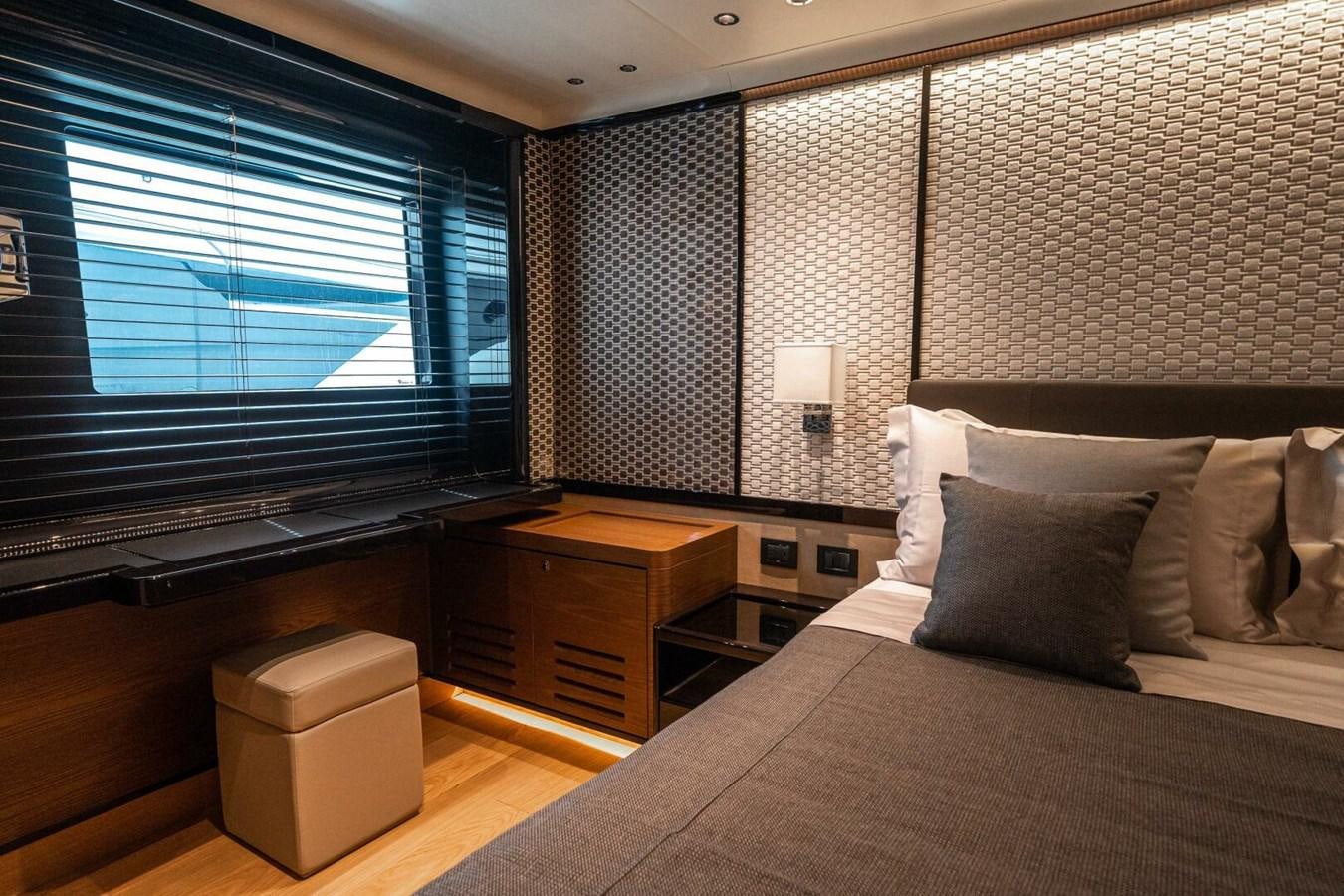 a bedroom with a bed and a desk aboard NAVETTA 68 Yacht for Sale