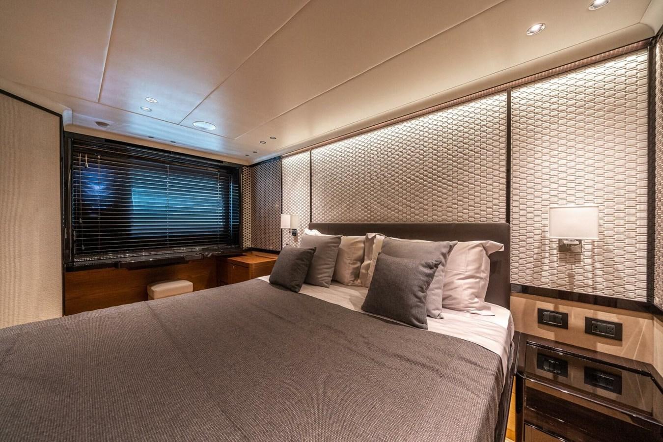 a bed with a television on the wall aboard NAVETTA 68 Yacht for Sale