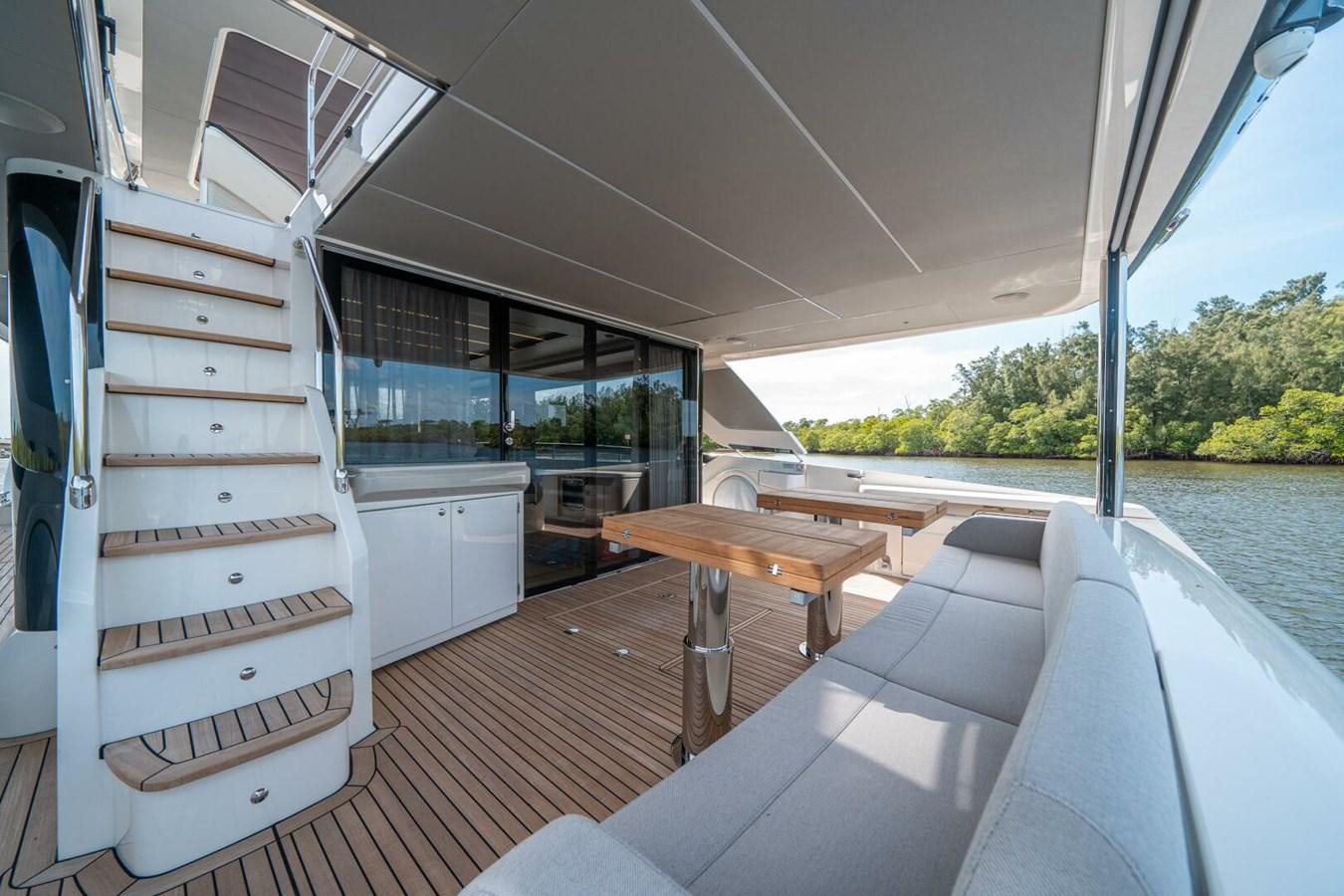 a boat with a deck and a table and chairs on a boat aboard NAVETTA 68 Yacht for Sale