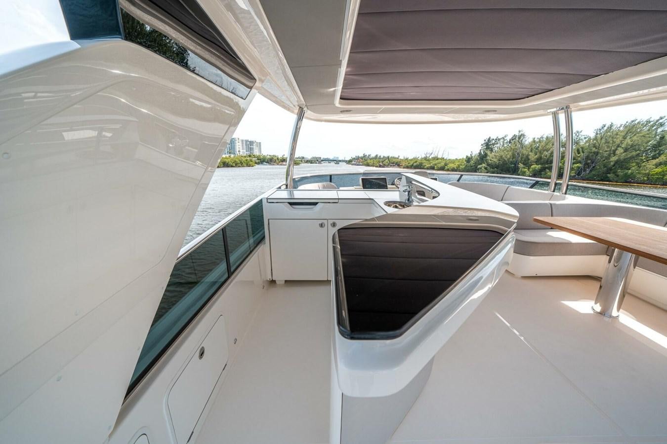 a room with a table and chairs aboard NAVETTA 68 Yacht for Sale