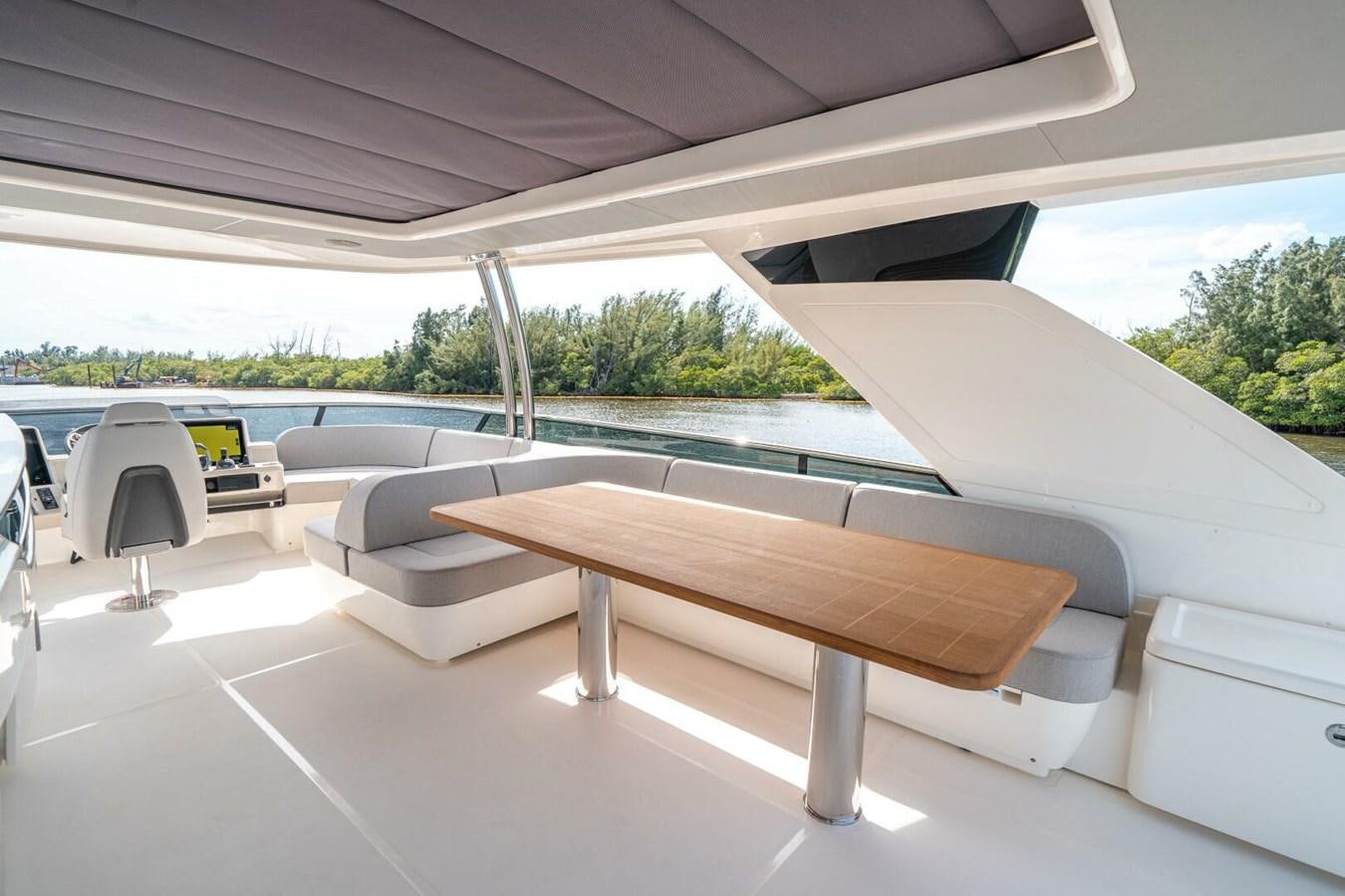 a table and chairs on a patio aboard NAVETTA 68 Yacht for Sale