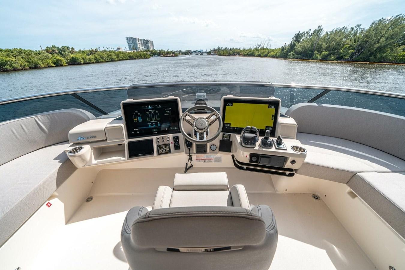a car with a screen and a steering wheel on the front aboard NAVETTA 68 Yacht for Sale