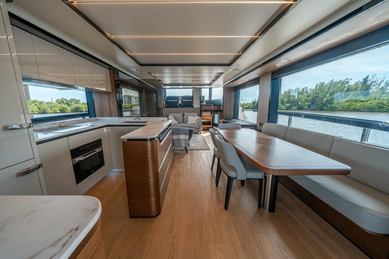 a room with a table and chairs aboard NAVETTA 68 Yacht for Sale