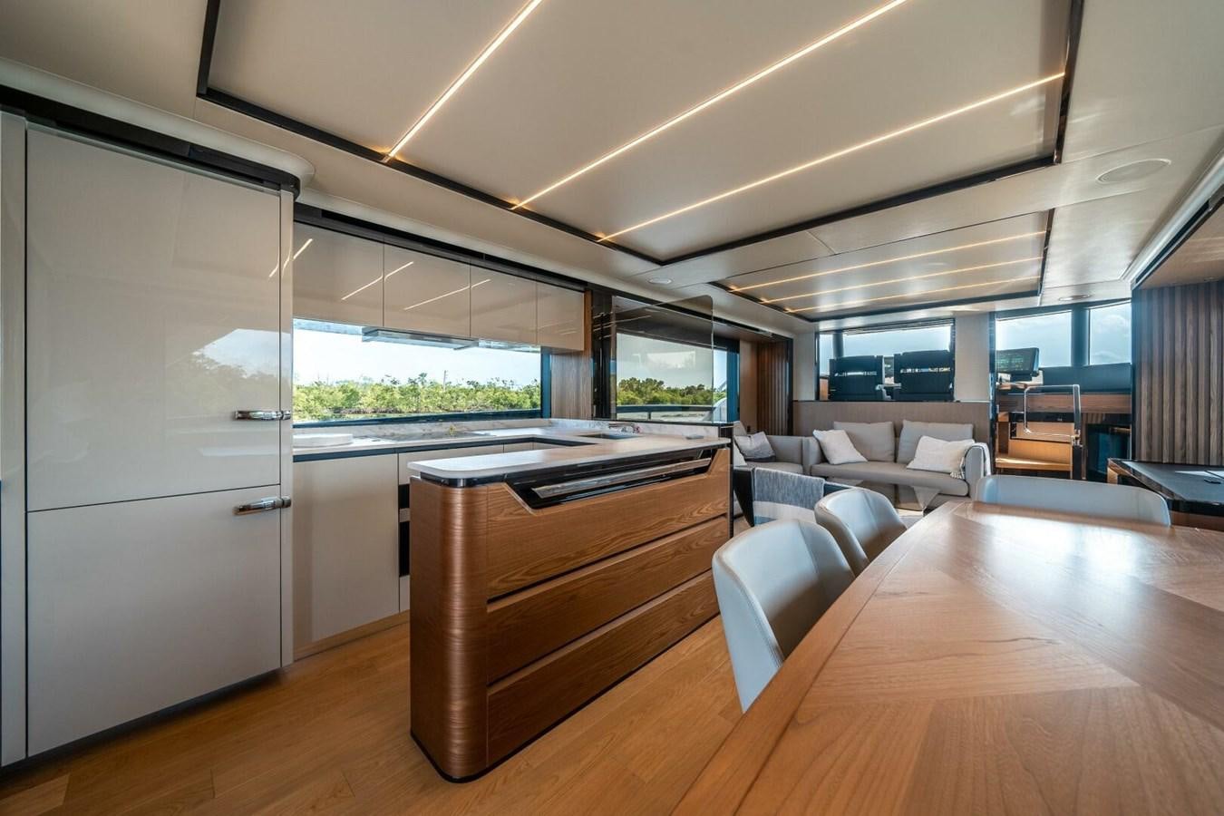 a room with a wood floor and a large window with a view of the city aboard NAVETTA 68 Yacht for Sale