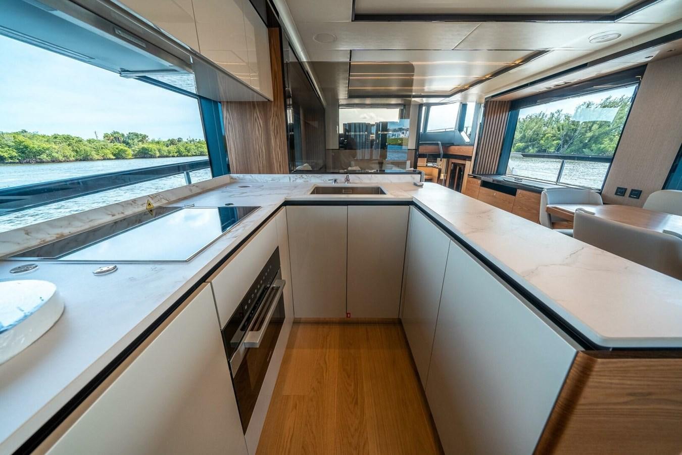 a kitchen with a large window aboard NAVETTA 68 Yacht for Sale