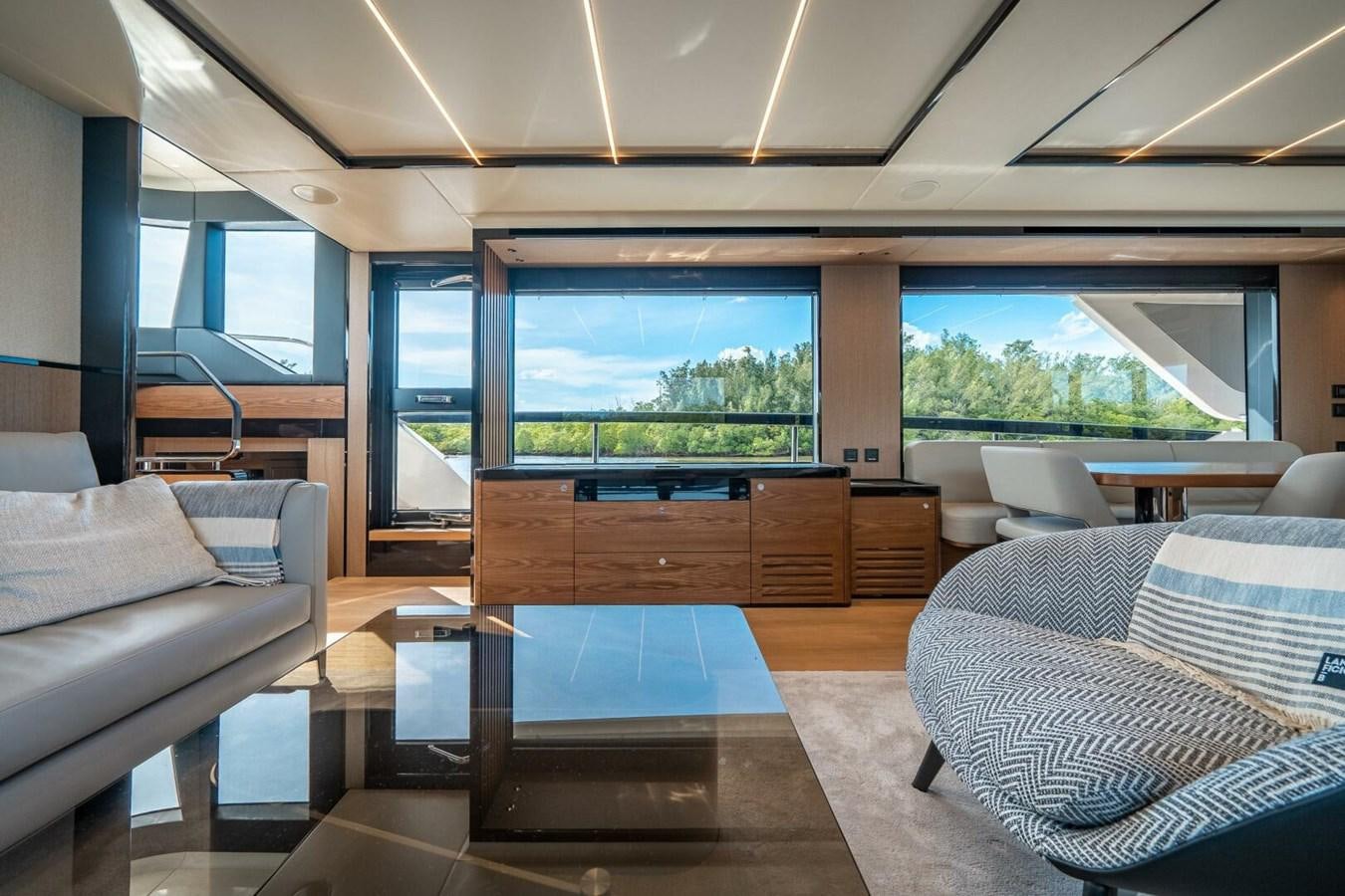 a room with a couch and a table and a window aboard NAVETTA 68 Yacht for Sale