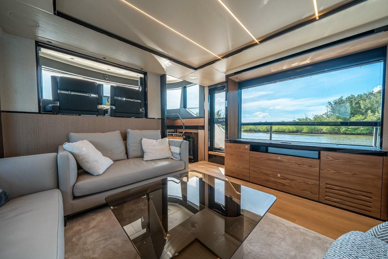 a living room with a large window aboard NAVETTA 68 Yacht for Sale