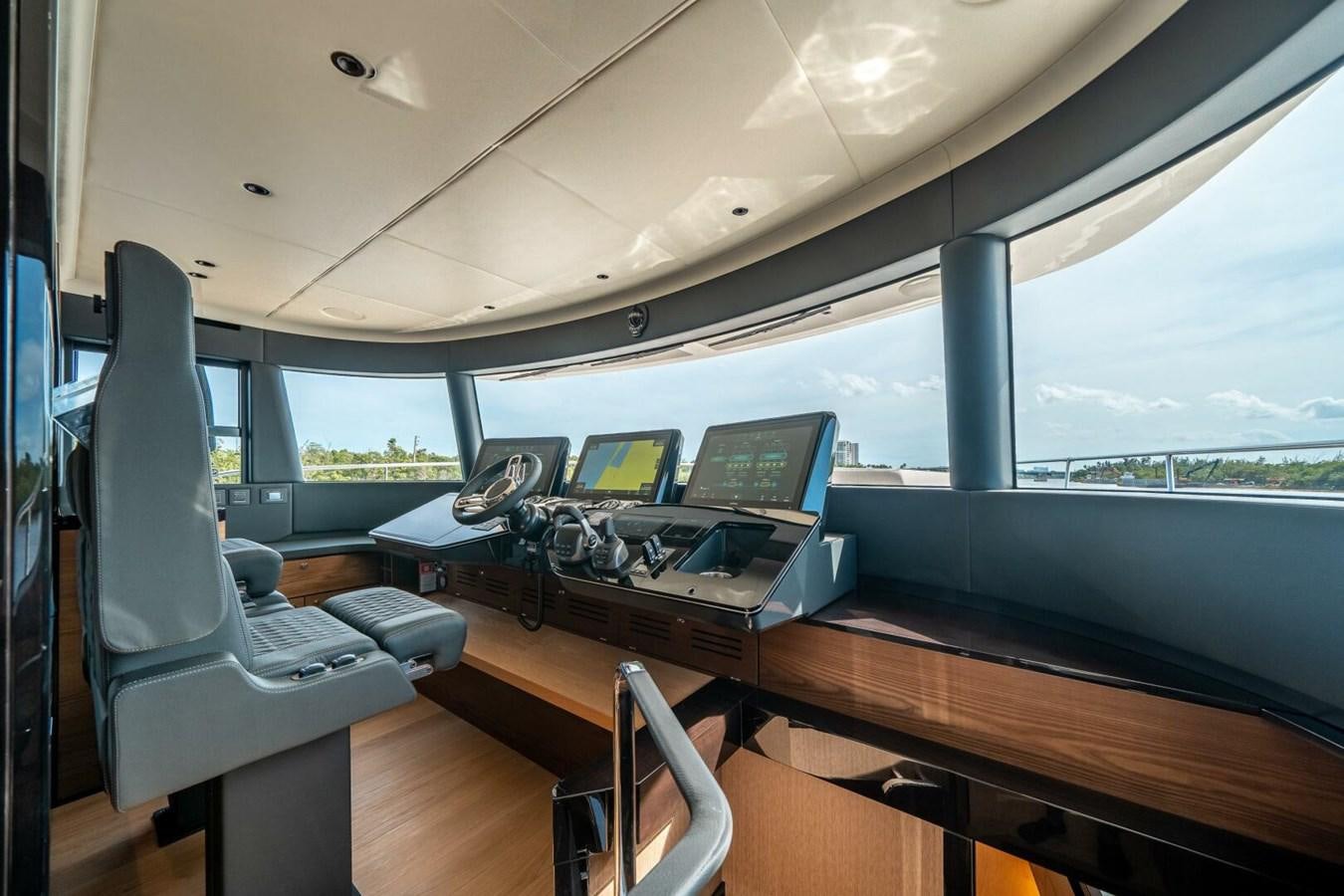 a room with a large window and a table with laptops on it aboard NAVETTA 68 Yacht for Sale