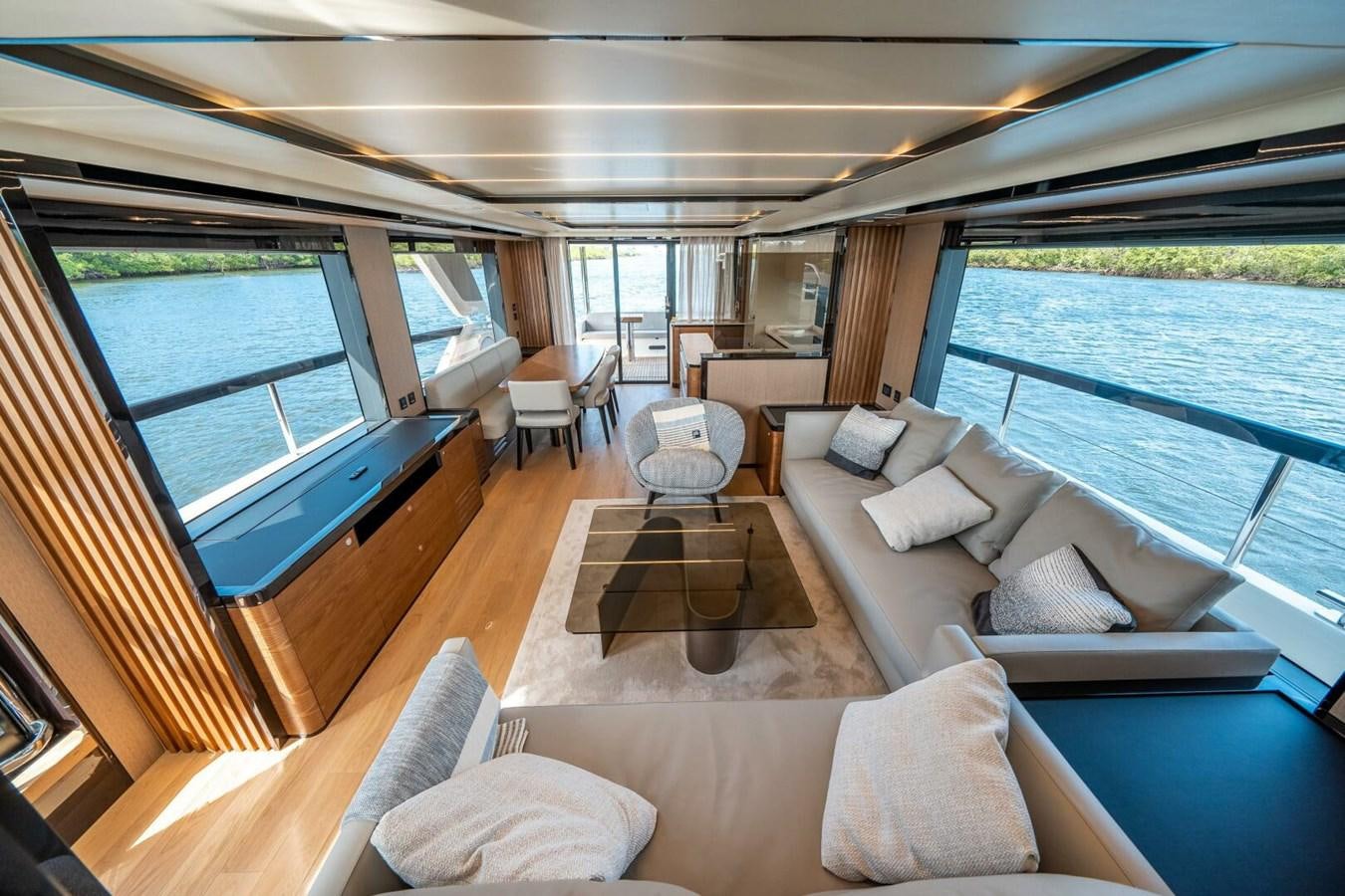 a large living room with a view of the water aboard NAVETTA 68 Yacht for Sale