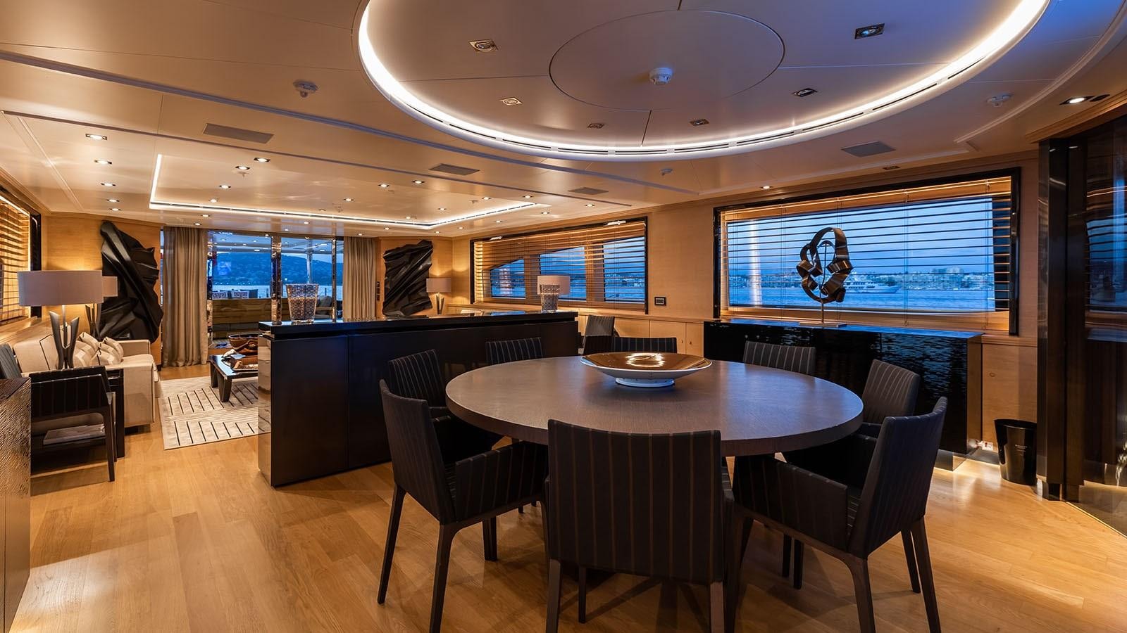 a large room with a table and chairs and a large screen aboard ALASKA Yacht for Sale