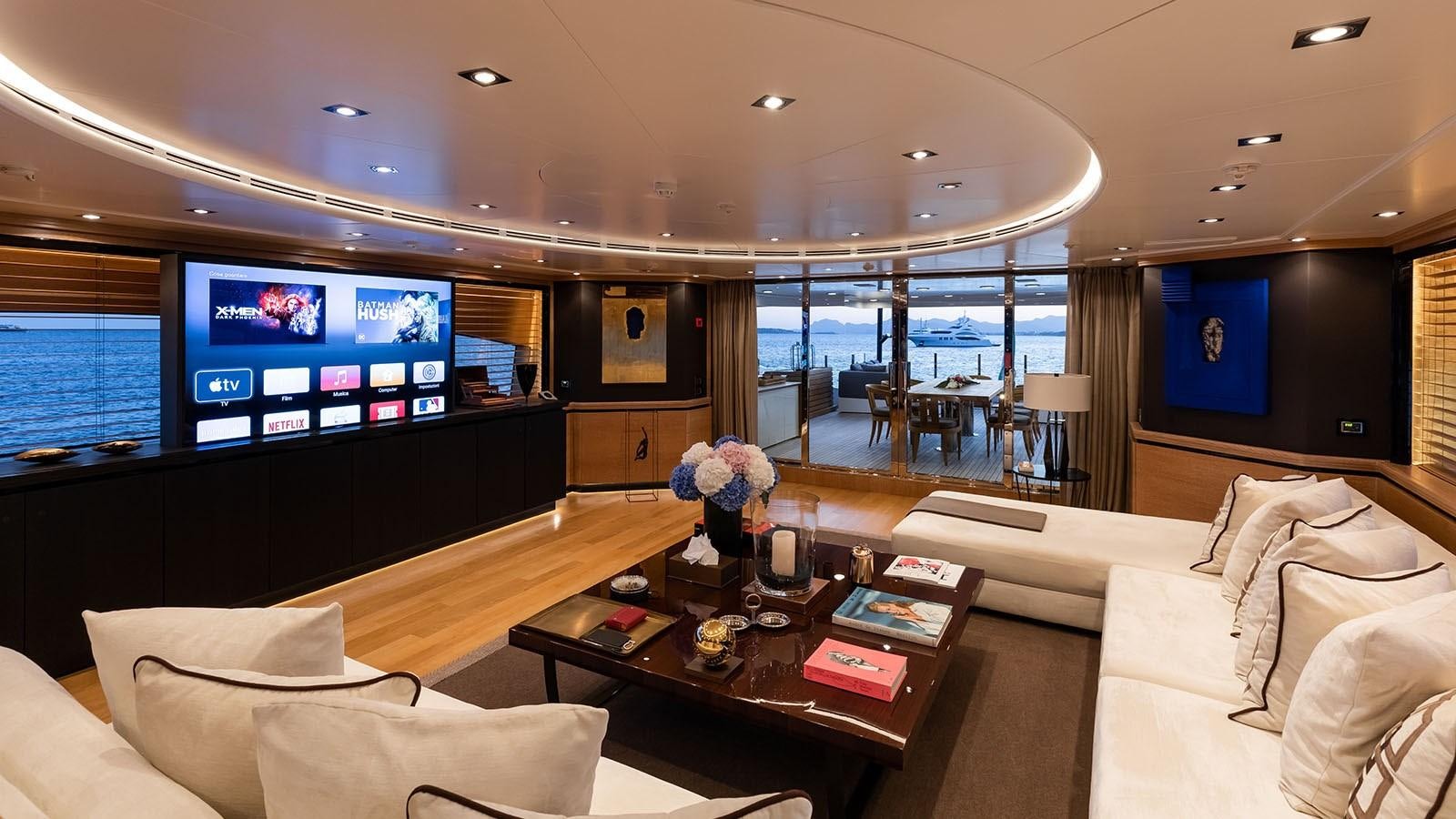 a living room with a large screen aboard ALASKA Yacht for Sale