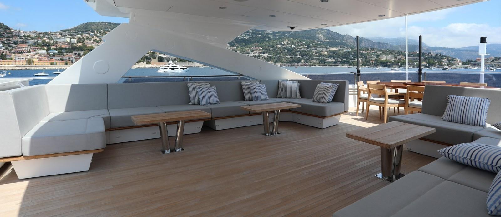 a room with a couch and a table and chairs aboard ALADDIN Yacht for Sale