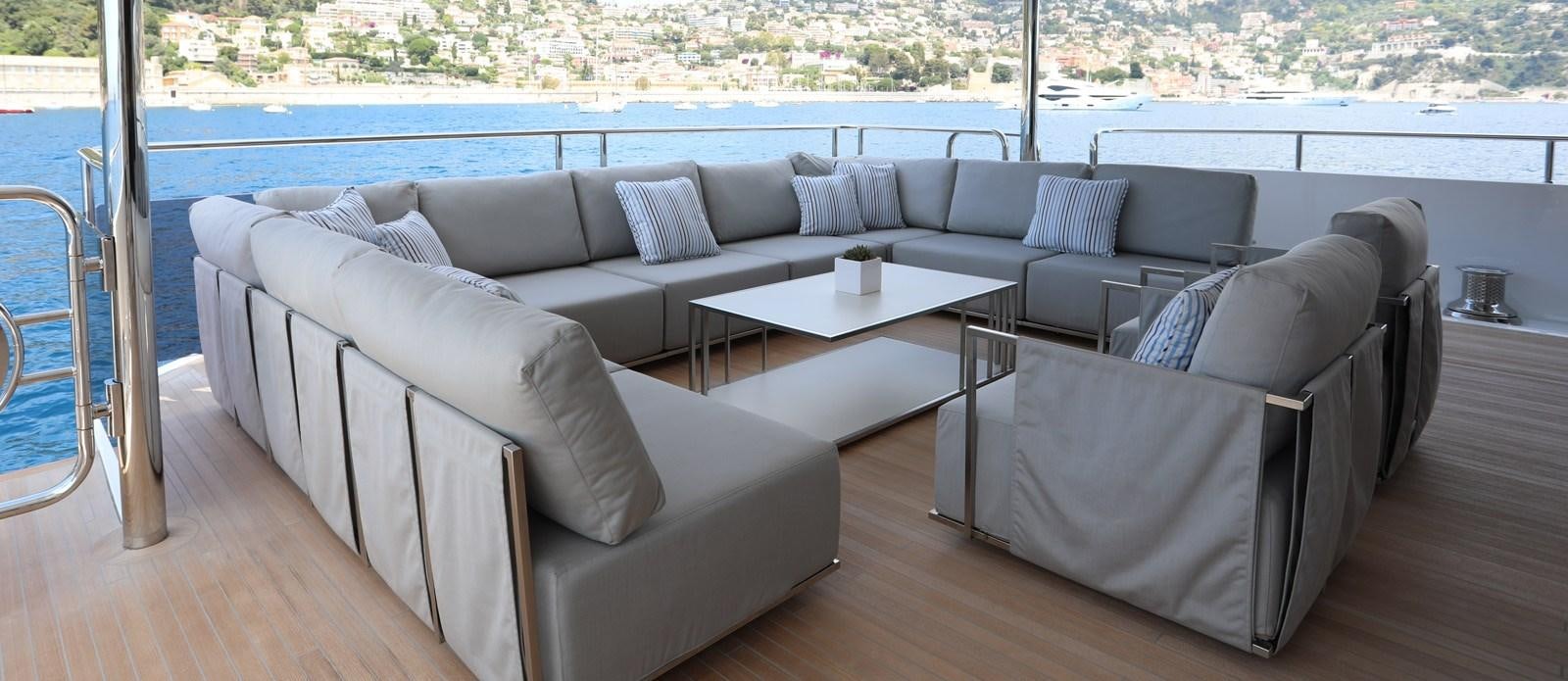 a couch and a table on a deck aboard ALADDIN Yacht for Sale